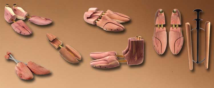 A collection of wooden shoe trees in various styles and designs, displayed on a brown gradient background. Each shoe tree features brass or metal hardware for adjustment and maintenance of shoe shape.