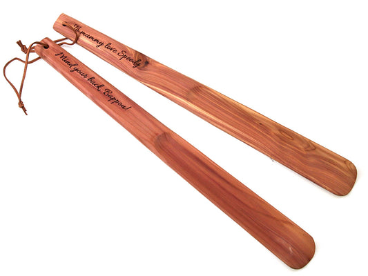 Two 40cm long cedar wood shoehorns from Cathcart Elliot feature smooth finishes and leather cords. One is engraved with The enemy of the speedy, and the other reads Mind your back, support.