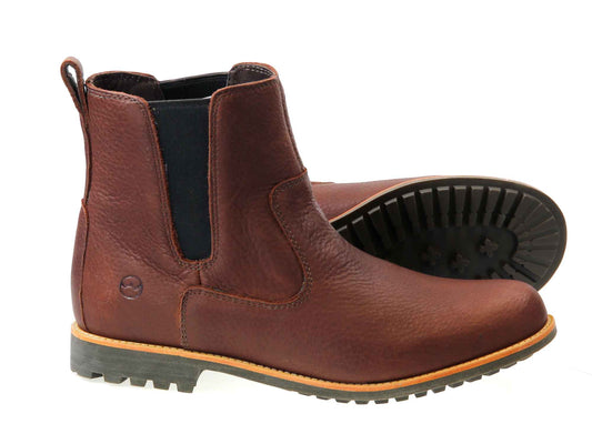 The Orca Bay Cotswold Ladies Dark Brown Chelsea Boots feature water-resistant leather, black elastic side panels, and a back pull tab. They include a rugged commando-style rubber sole with a tread pattern, ideal for outdoor adventures.