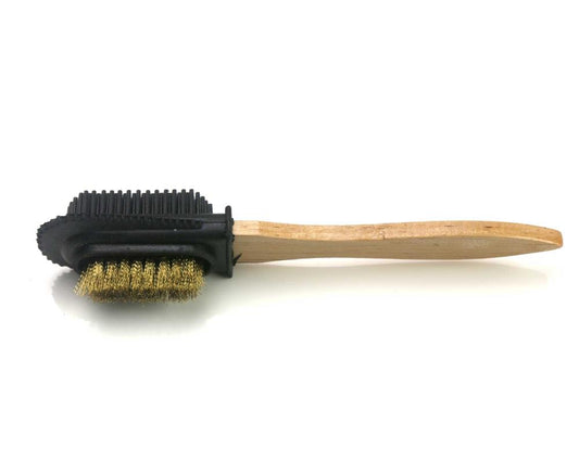 The *seconds* suede cleaning brush by Cathcart Elliot is dual-sided with a wooden handle. One side has gold metal bristles for scrubbing, and the other has black rubber bristles for gentle suede and nubuck cleaning, positioned horizontally with the handle on the right.