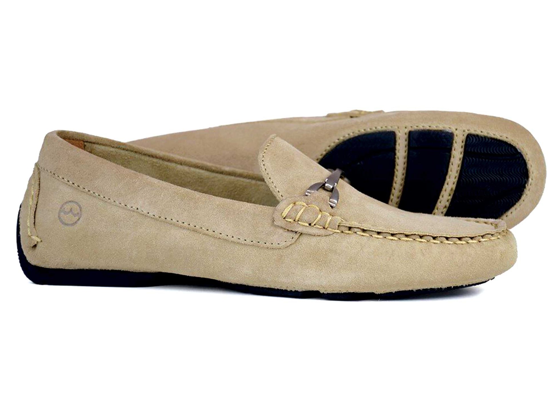 The SORRENTO Ladies Alpaca Beige Suede Buckled Loafer by Orca Bay features decorative stitching, a shiny metallic bit, a side logo, and black rubber soles for optimal traction.