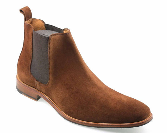 The BROMPTON Mens Brown Suede Chelsea Boot by Orca Bay exudes premium charm with a sleek design, featuring an elastic side panel, back pull tab, and a leather sole with a slight heel. Its smooth, polished finish enhances its elegance.