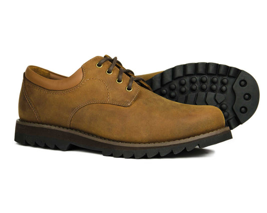 The BILBURY Mens Sand Nubuck Leather Country Derby Shoes by Orca Bay feature rugged rubber soles. Displayed with one shoe upright and the other tilted, they showcase their classic design, perfect for casual wear.