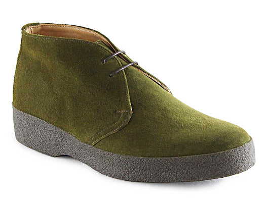 The HI TOP Mens Moss Green Suede Chukka Boot by Sanders features dark laces, a thick crepe sole, and a minimal design with clean lines and a short ankle cut. The image of this stylish boot is set against a white background, reminiscent of classic James Bond aesthetics.