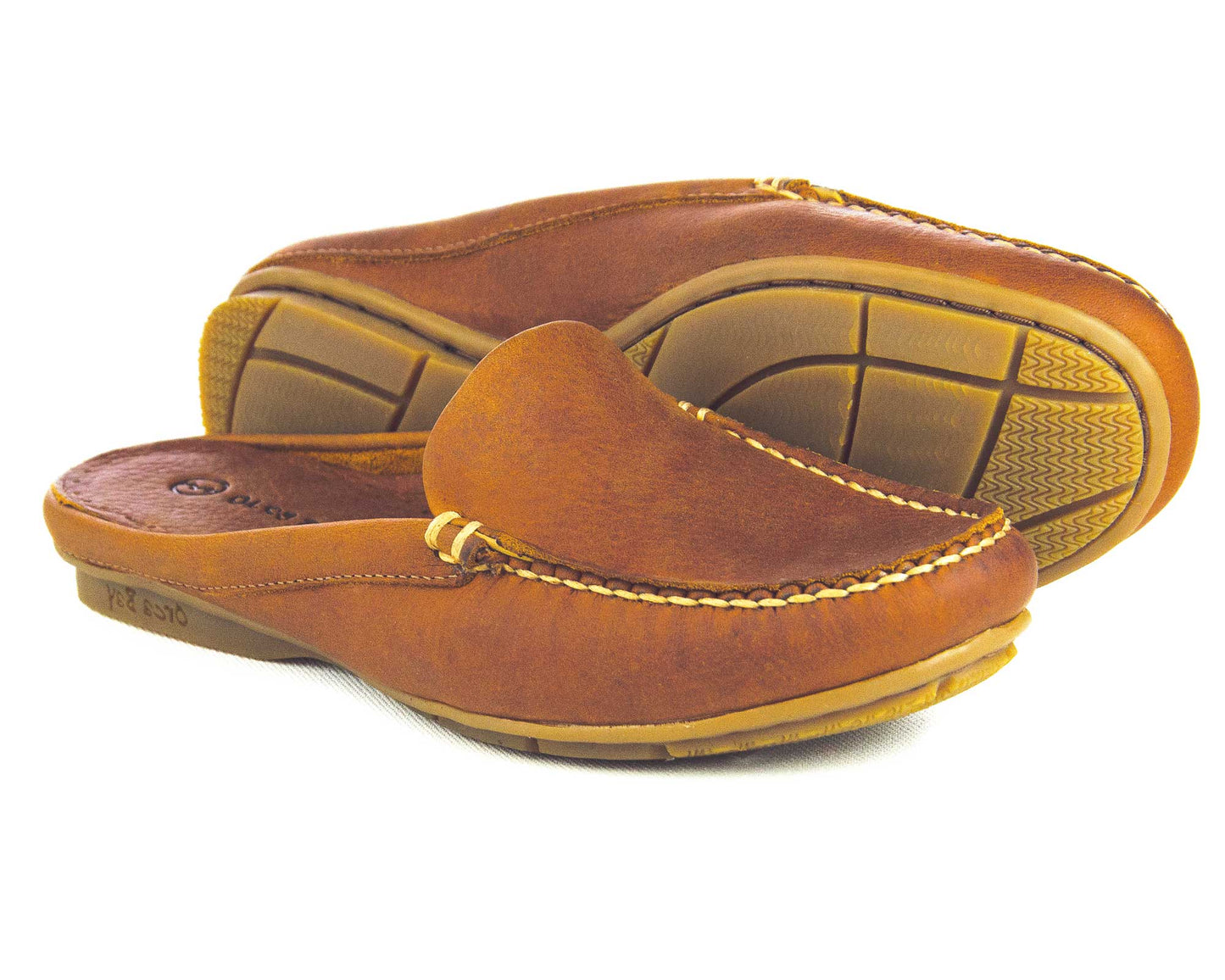 Orca Bays SALE Womens Leather Mule Shoe in Havana leather features visible stitching and a textured, non-slip sole. The display showcases one shoe upright and the other on its side to highlight the intricate sole pattern.