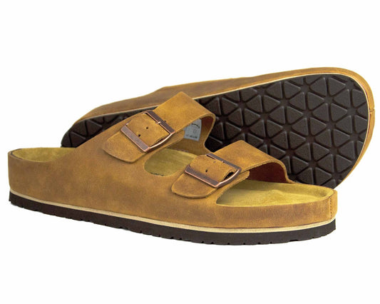 The SABA Mens Sandal Sand by Orca Bay, featuring brown leather, two adjustable straps, a cushioned footbed, and dark textured soles, is displayed against a white background.