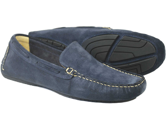 Orca Bays SILVERSTONE Mens Navy Nubuck Leather Driving Shoes are shown with one upright and the other on its side, showcasing black rubber outsoles, beige stitching, and a tan interior lining for style and comfort.