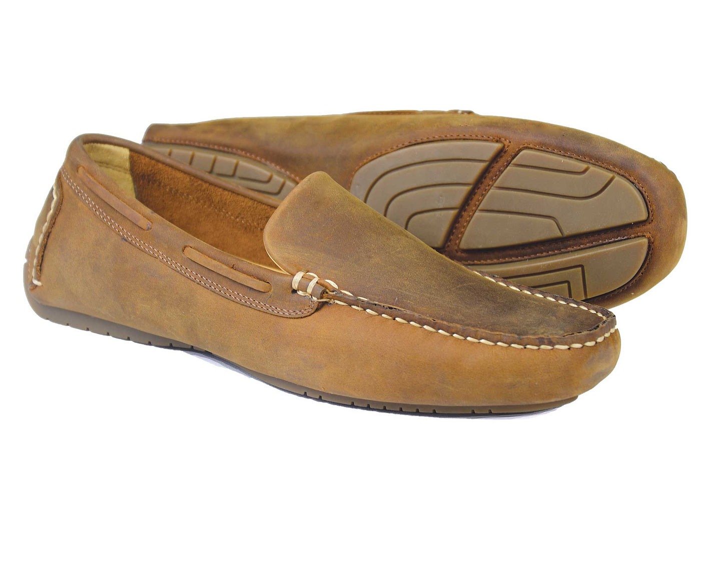 A pair of Orca Bays SILVERSTONE Mens Sand Nubuck Leather Driving Shoes, one upright and one on its side, highlights their textured rubber soles and detailed stitching. These versatile shoes are perfect for casual or semi-formal wear.