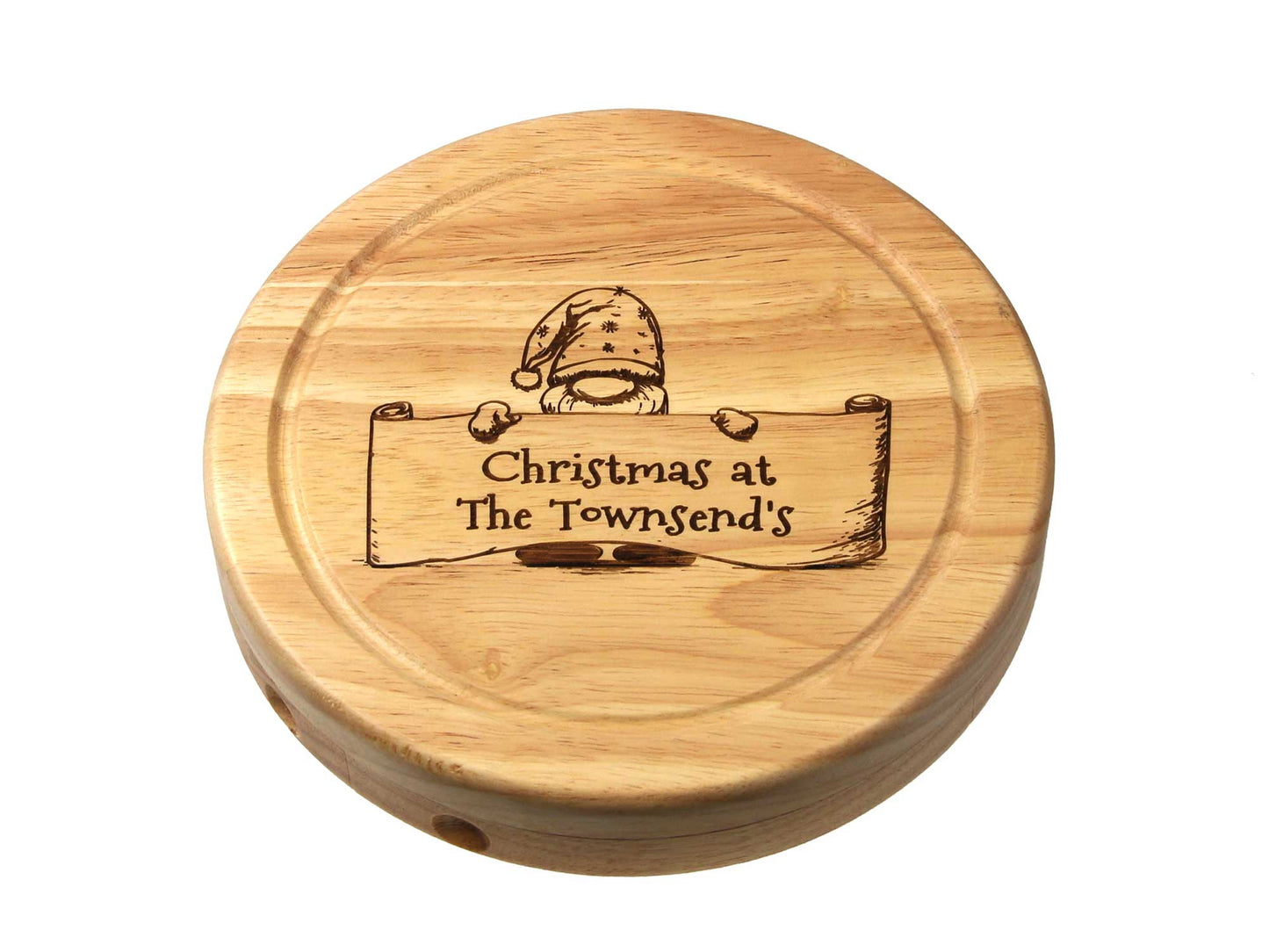 The Cathcart Elliot *Second* personalisable 19cm round cheeseboard gift set includes a wire cutter and tongs. It features an engraved image of a gnome with a scroll reading Christmas at The Townsends, making it perfect for festive gatherings or as a charming gift for loved ones.